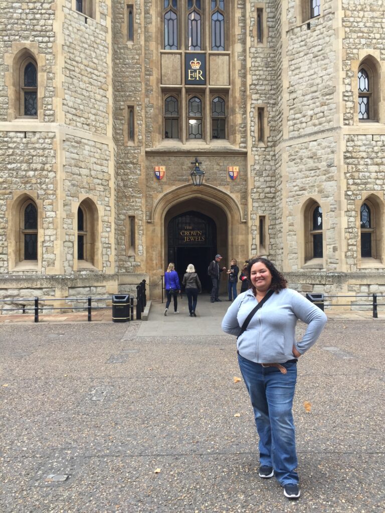 Jessica, owner of daydreams and wanderlust is standing in front of the building that holds the Royal Jewels at the Tower of London in 2017